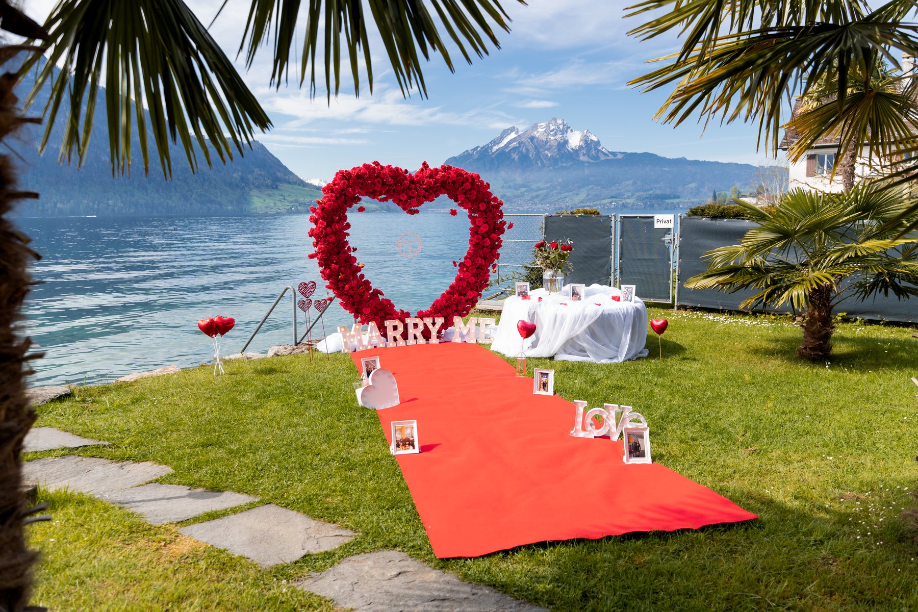 Red rose heart and red carpet by Lake Lucerne with Mount Pilatus behind