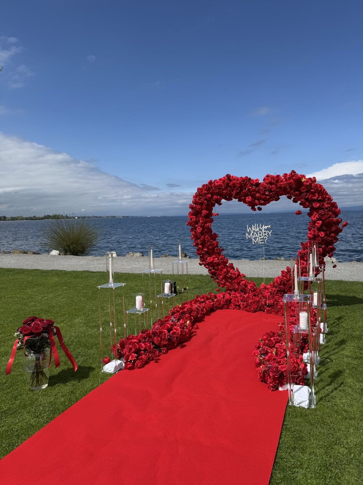 Red rose heart and Will You Marry Me sign on the shore of Lake Constance