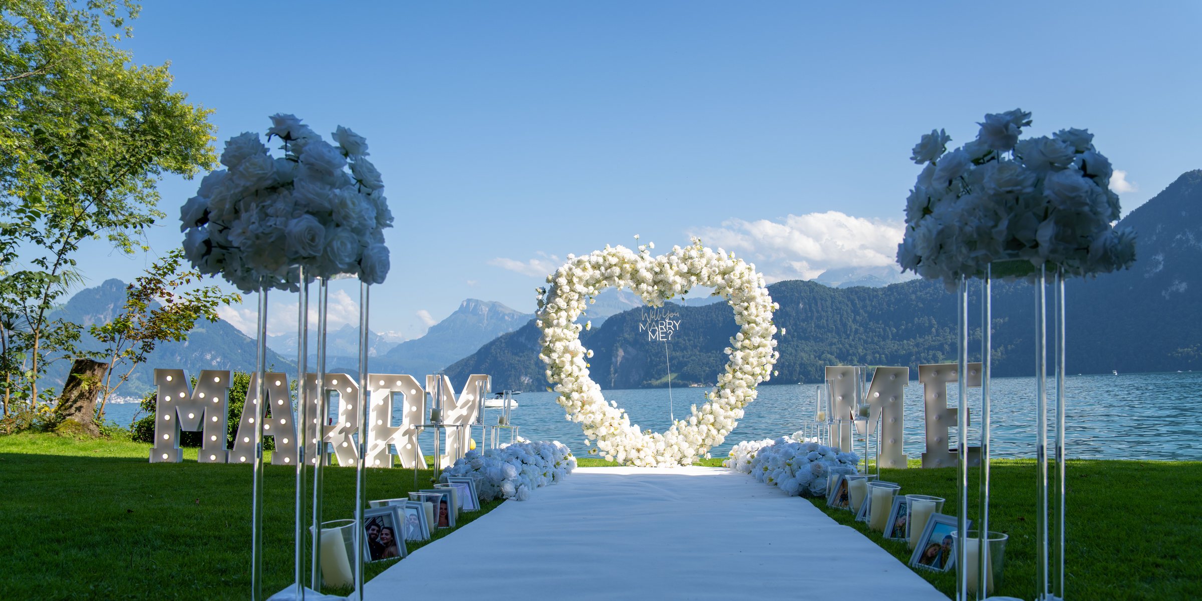 White rose heart and illuminated Marry Me letters on the shore of Lake Lucerne, Switzerland